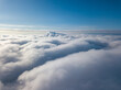 © Sergey - Aerial view. Flying over white clouds during the day in sunny weather.