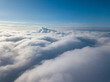 © Sergey - Aerial view. Flying over white clouds during the day in sunny weather.