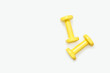 © Natasha  - Yellow dumbbells isolated on white background. View from above.