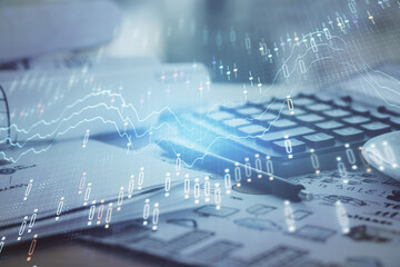 Double exposure of financial chart drawings and desk with open notebook background. Concept of forex market