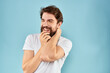 © SHOTPRIME STUDIO - Cheerful man gesturing with his hands emotions cropped view on blue background studio