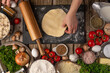 © Anton - Chef hands with the dough and rolling pin on wooden table with variety of ingredients background. Concept of cooking process. Backstage of preparing tasty meal. View from above.