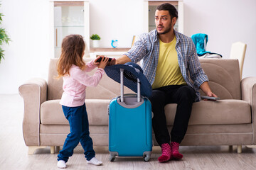 Young man and his small daughter preparing for the trip