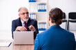 © Elnur - Young male candidate employee meeting with old recruiter