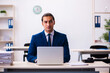© Elnur - Young male employee working in the office