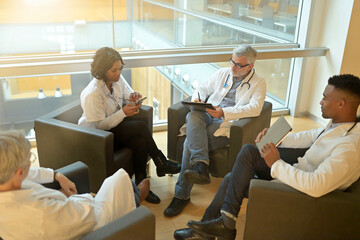 Wall Mural - Medical people sitting in meeting room, checking planning together