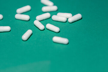 close up. capsules with medicine on a green background.