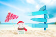 © pim pic - wooden billboard and Christmas decoration on sand beach, image for Christmas holiday vacation concept.