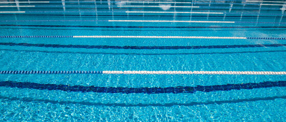 Wall Mural - Olympic Swimming pool background on a bright Sunny day