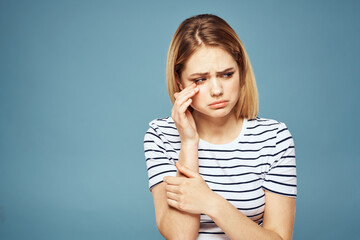 Wall Mural - Upset woman emotions displeasure gestures with hands blue background