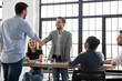 © fizkes - Congratulate you on promotion. Male leader ceo boss handshaking with happy young man worker greeting with financial reward, salary or career growth, appreciating for good job, welcoming new teammate