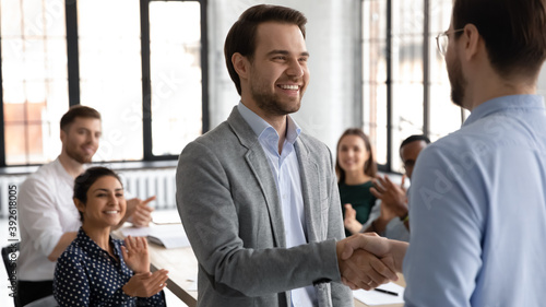 Fotomural Happy motivated millennial man intern is being hired on regular job employed to