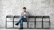 © fizkes - Time is money. Serious young businessman job applicant sitting at company office employment agency hall expecting for interview looking at wrist watch checking time thinking he is waiting too long