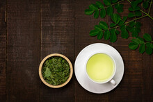 Moringa Tea On Wooden Background. Moringa Oleifera Tropical Herb Healthy Lifestyle Concept.
