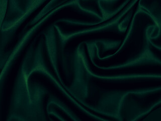 Deep, rich, emerald coloured satin. Folded and flowing background. Decoration design. Soft focus. Luxury and sexy concept. Dark green silk backdrop with curves, luxury fashion.