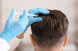 © Prostock-studio - Unrecognizable man having hair treatment at beauty salon