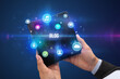 © ra2 studio - Businessman holding a foldable smartphone with BLOG inscription, social media concept