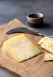 © orlio - Peace of cheese sliced on a wooden board