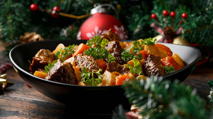 Christmas Beef Stew with decoration, gifts, green tree branch on wooden rustic table