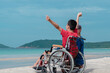 © GAYSORN - Asian special child on wheelchair is smiling, playing, doing activity on  sea beach with father,Lifestyle of disability child, Life in the education age, Happy disabled kid in travel holidays concept.