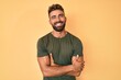 © Krakenimages.com - Young hispanic man wearing casual clothes happy face smiling with crossed arms looking at the camera. positive person.