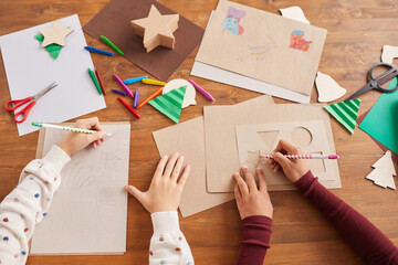 Top view close up of children drawing pictures during art and craft class in school, copy space