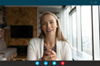 © fizkes - Computer application head shot display view smiling young blonde 30s woman talking looking at web camera, successful businesswoman holding online video call negotiations meeting with partners.