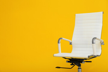 Modern office chair on yellow background. Space for text