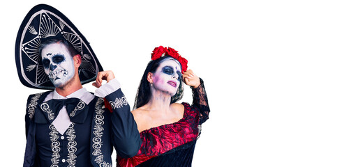 Canvas Print - Young couple wearing mexican day of the dead costume over background stretching back, tired and relaxed, sleepy and yawning for early morning