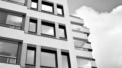 Detail of modern residential flat apartment building exterior. Fragment of new luxury house and home complex. Black and white.