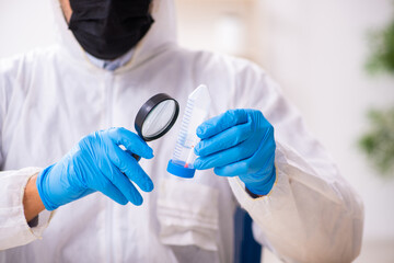 Wall Mural - Male expert criminologist working in the lab for evidence