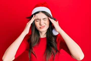 Sticker - Young beautiful caucasian girl wearing christmas hat suffering from headache desperate and stressed because pain and migraine. hands on head.