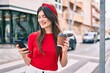 © Krakenimages.com - Young caucasian woman smiling happy using smartphone walking at the city.
