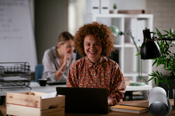 Wall Mural - Happy businesswoman working on laptop.