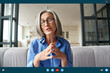 © insta_photos - Senior mature old woman online teacher, remote tutor, distance coach talking to web cam virtual counseling conference video calling at home office. Web cam view. Videocall app screenshot screen view