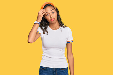 Wall Mural - Young african american girl wearing casual clothes worried and stressed about a problem with hand on forehead, nervous and anxious for crisis