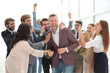 © ASDF - happy team of employees congratulating their colleague.