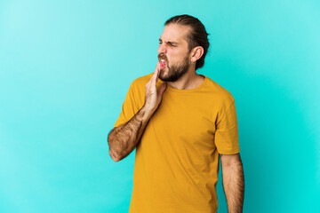 Wall Mural - Young man with long hair look having a strong teeth pain, molar ache.