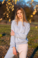 Wall Mural - Young smiling happy fashion woman in autumn field