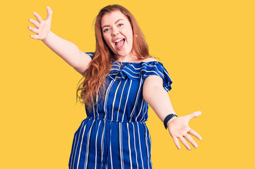 Sticker - Young beautiful redhead woman wearing casual clothes looking at the camera smiling with open arms for hug. cheerful expression embracing happiness.