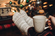 © Юлія Мартинюк - Feet in Christmas socks. Close up on feet. Winter and Christmas holidays concept. The cup of hot drink. Cozy scene. Background with christmas decor. Christmas background.