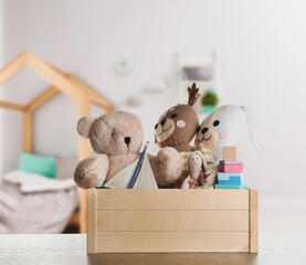 Poster - Set of different cute toys on wooden table in children's room