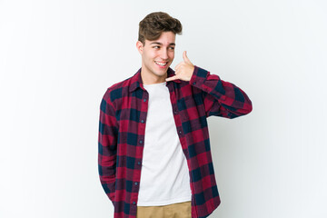 Wall Mural - Young caucasian man isolated on white background showing a mobile phone call gesture with fingers.