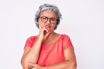 Sticker - Senior hispanic grey- haired woman wearing casual clothes and glasses thinking looking tired and bored with depression problems with crossed arms.