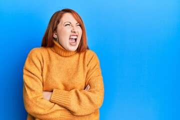 Sticker - Beautiful redhead woman with arms crossed gesture angry and mad screaming frustrated and furious, shouting with anger. rage and aggressive concept.