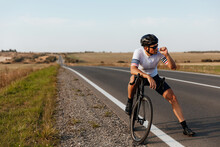 Cyclist Relaxing On Road And Eating Sports Nutrition