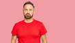 © Krakenimages.com - Handsome middle age man wearing casual red tshirt puffing cheeks with funny face. mouth inflated with air, crazy expression.