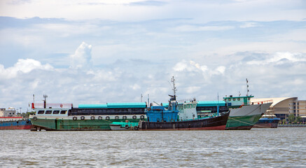 A cargo ships moored in the middle of the river Chao Phraya, Samut Prakan, Thailand.