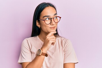 Poster - Young asian woman wearing casual clothes and glasses thinking concentrated about doubt with finger on chin and looking up wondering