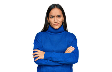 Wall Mural - Young asian woman wearing casual winter sweater skeptic and nervous, disapproving expression on face with crossed arms. negative person.